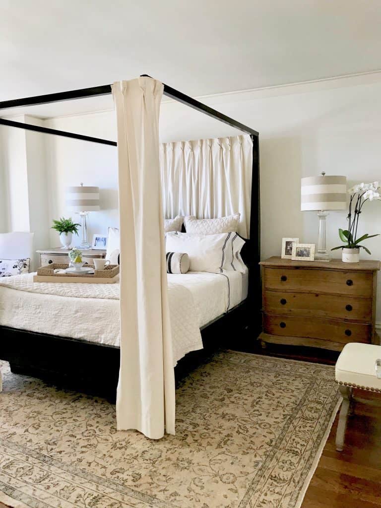 black four poster bed and vintage Turkish rug
