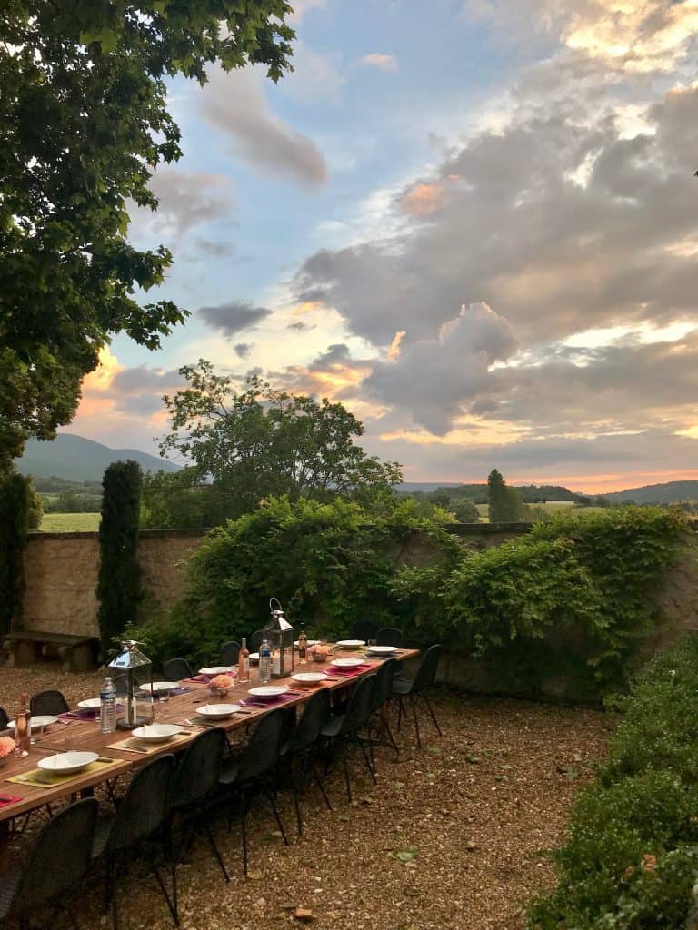 table set for dinner in Provence with sun setting