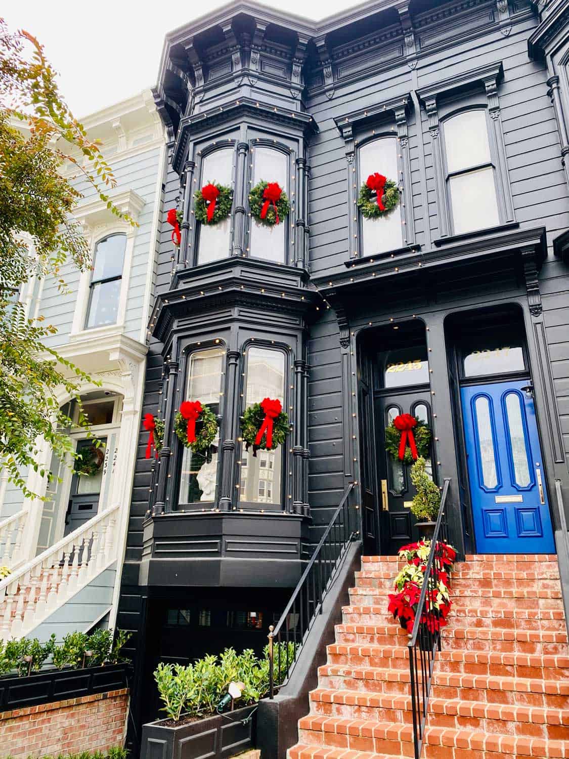 Black Victorian Home with Christmas Wreaths