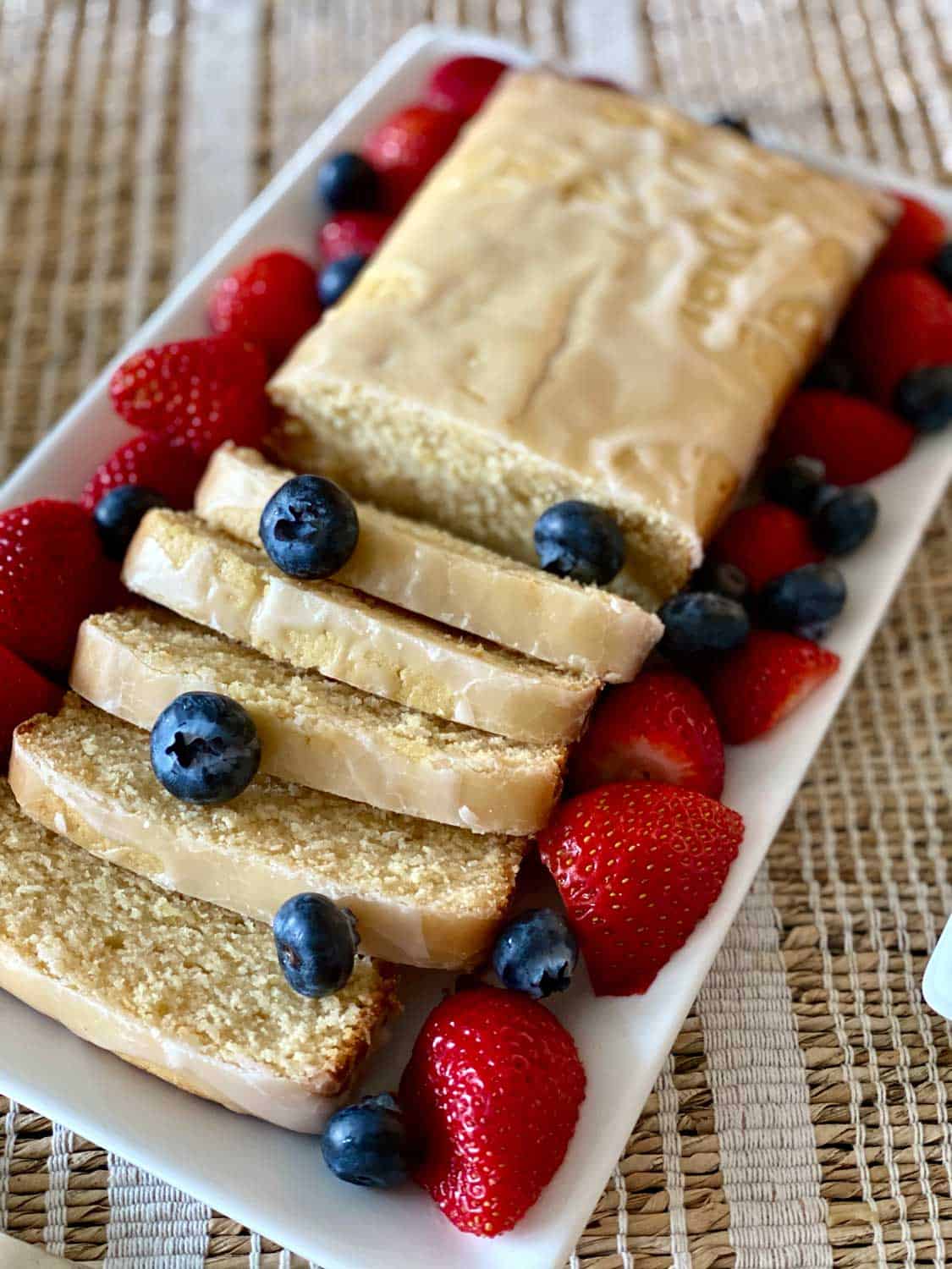 close up of sliced Lemon Cake with berries