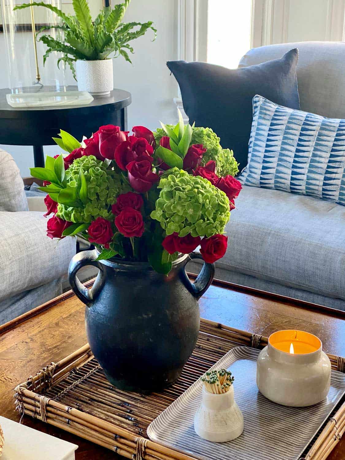 Red roses and green hydrangea flower arrangement on coffee table