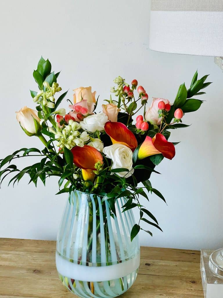 Colorful lilies and peach roses from Farm Girl Flowers