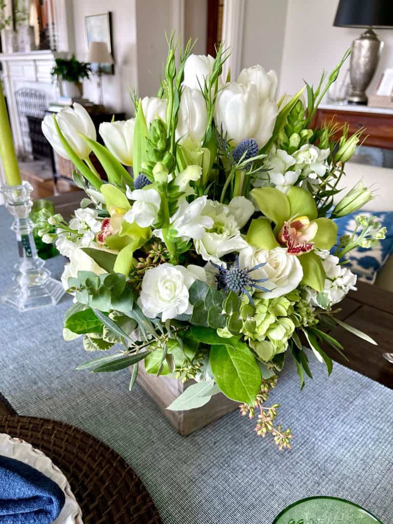 White flower centerpiece with green orchids