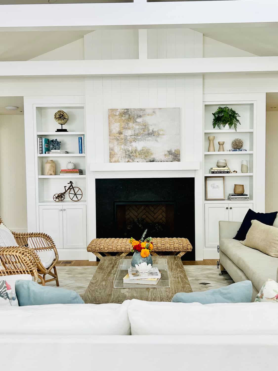 white great room  with bookcases and fireplace