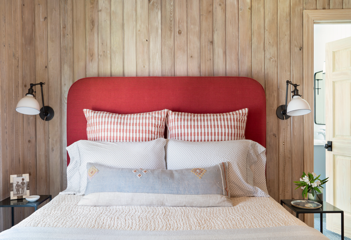 beach bedroom with red headboard