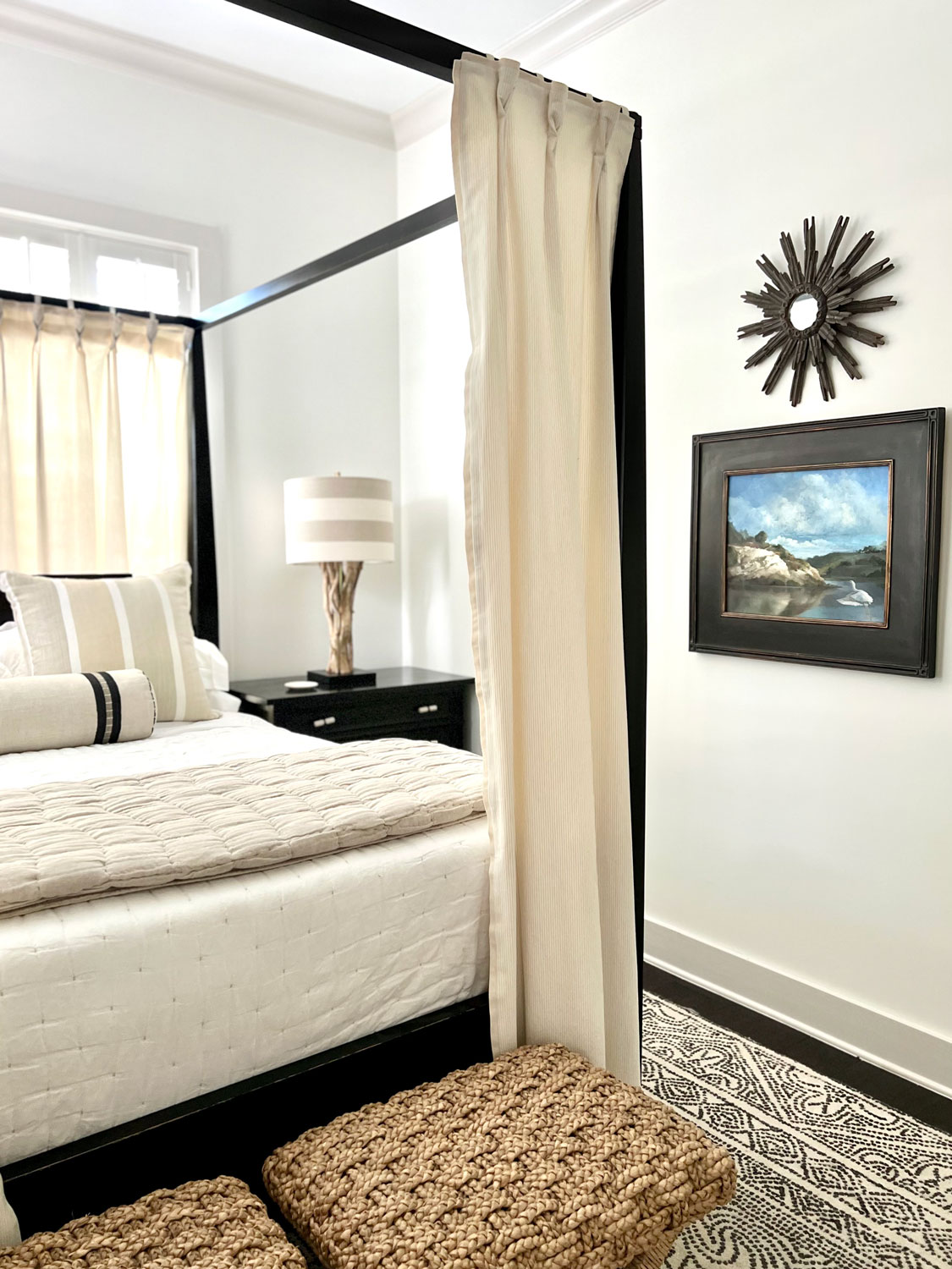 coastal painting and starburst mirror in guest room