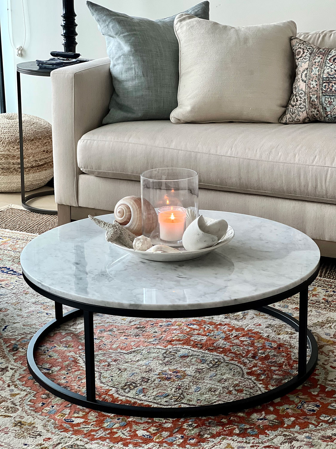 Round marble topped coffee table in downsized apartment