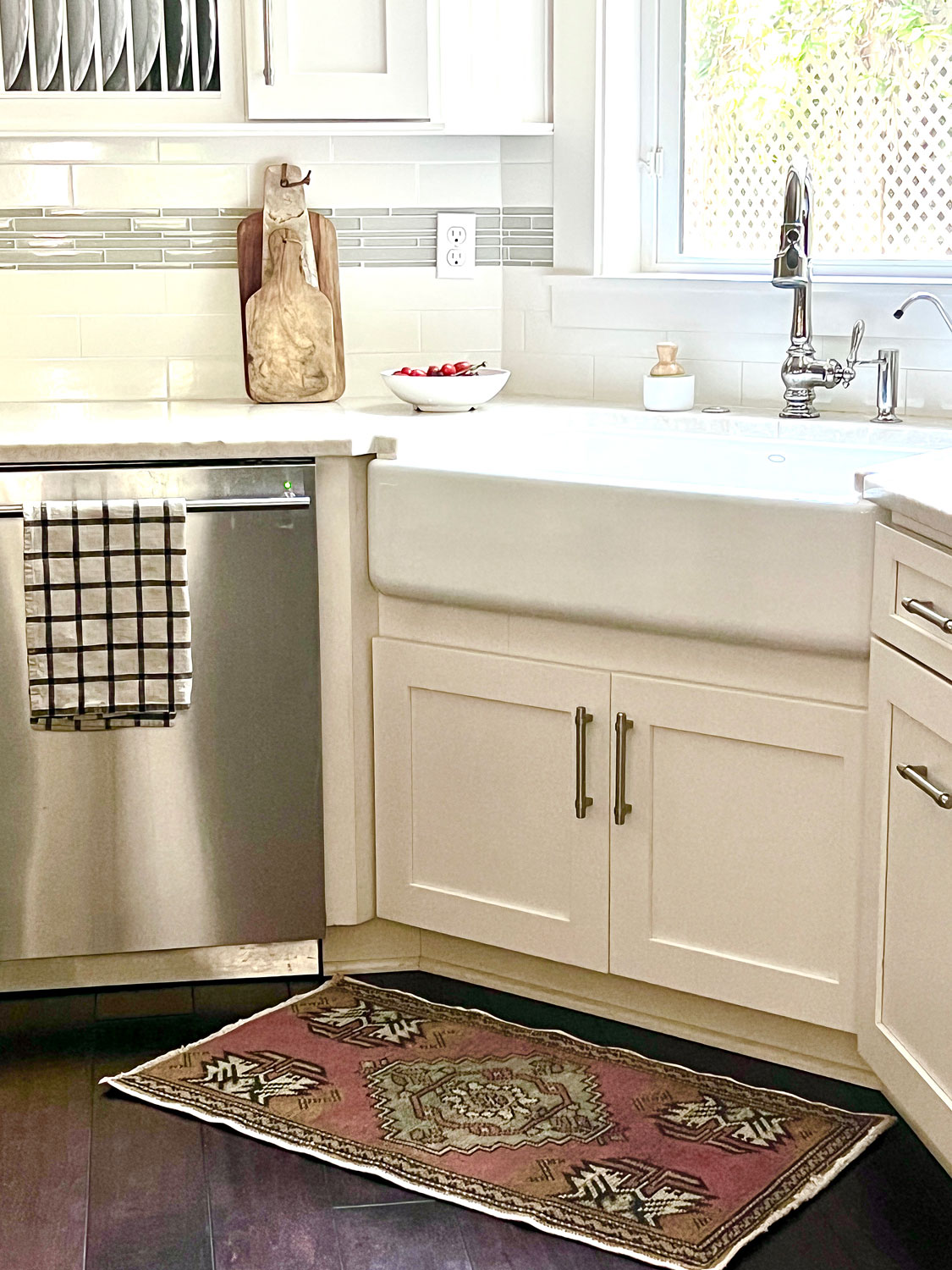 kitchen sink with plate rack and vintage rug